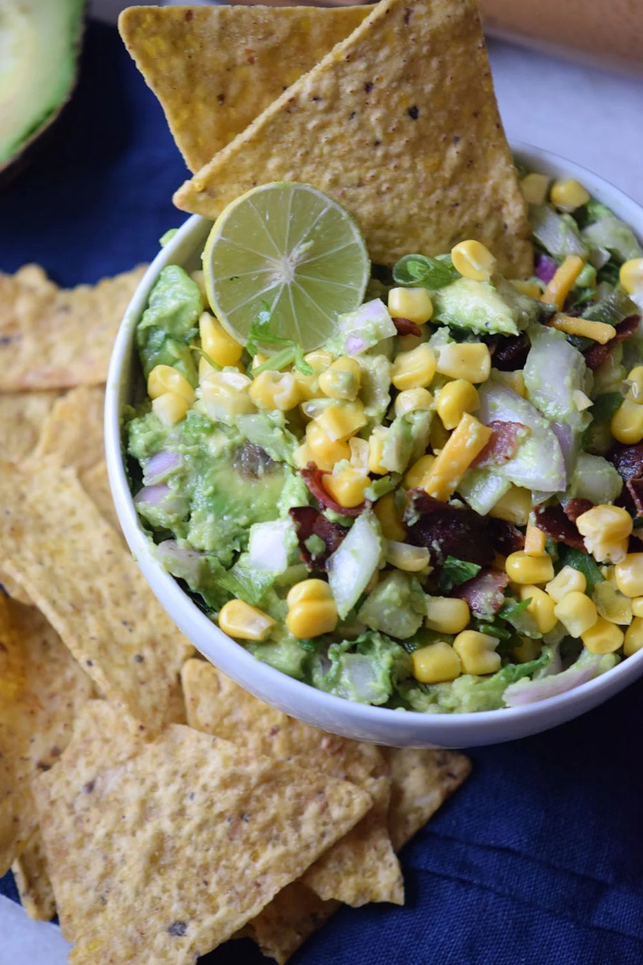 Need a yummy appetizer to bring to a party? Try this delicious bacon corn guacamole recipe via Bekob.com