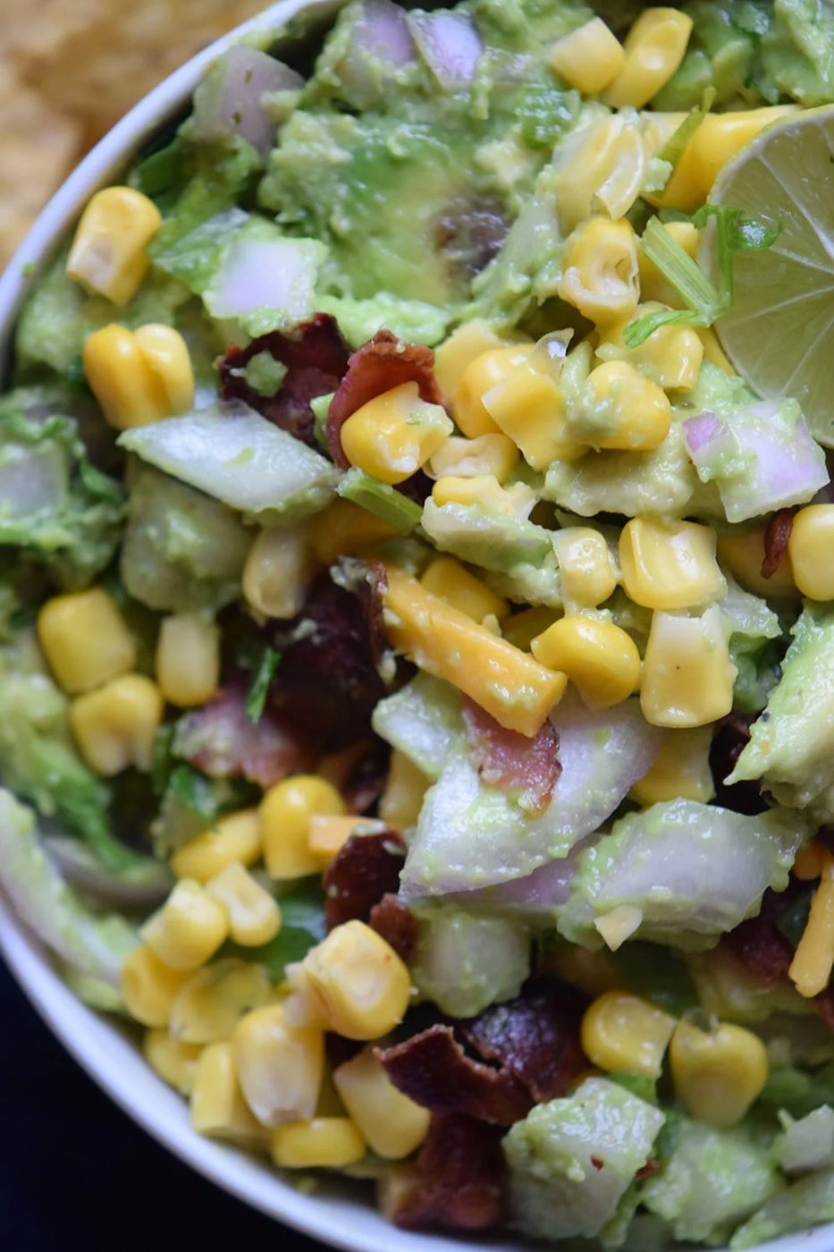 Need a yummy appetizer to bring to a party? Try this delicious bacon corn guacamole recipe via Bekob.com