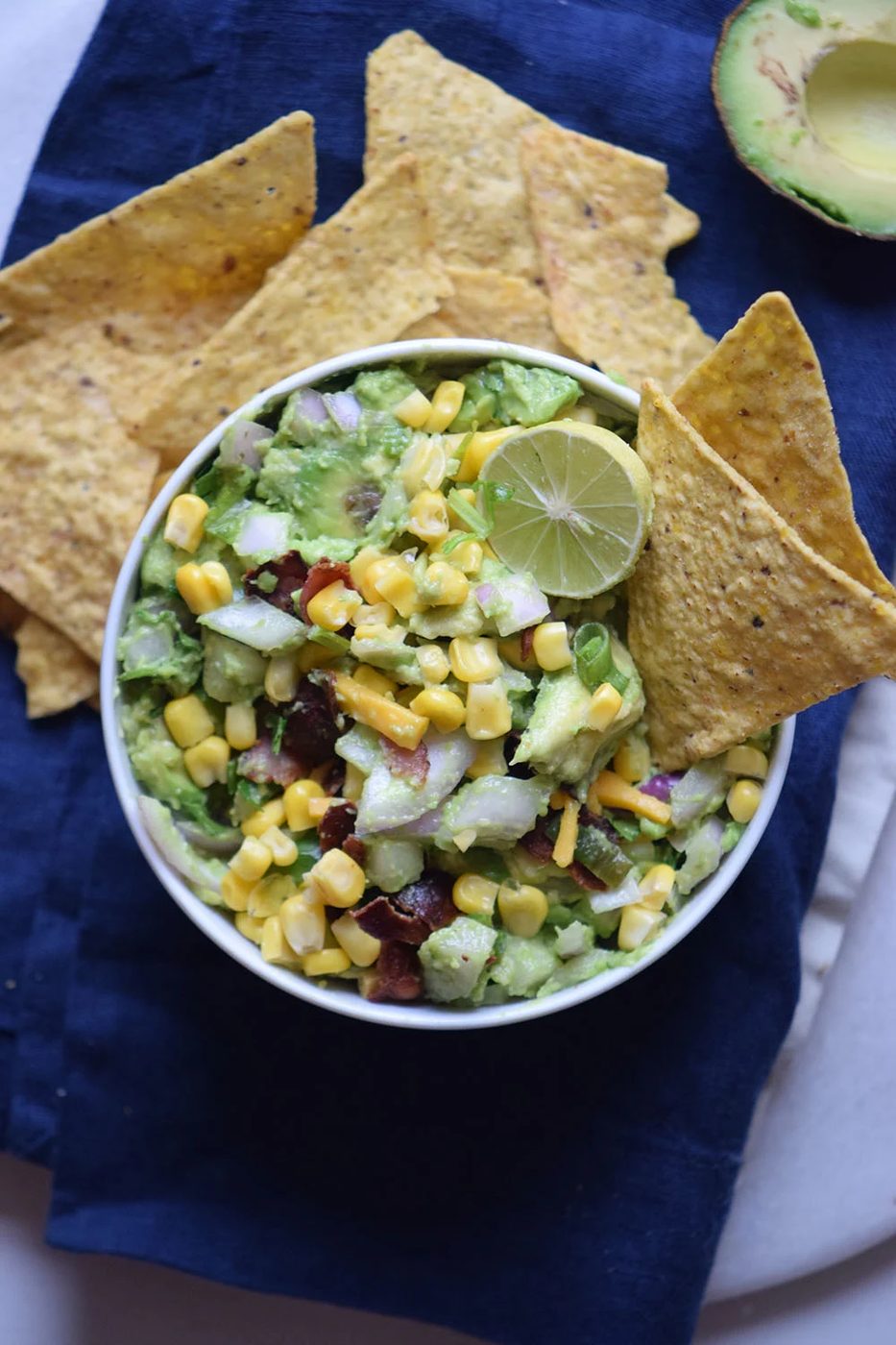 Need a yummy appetizer to bring to a party? Try this delicious bacon corn guacamole recipe via Bekob.com