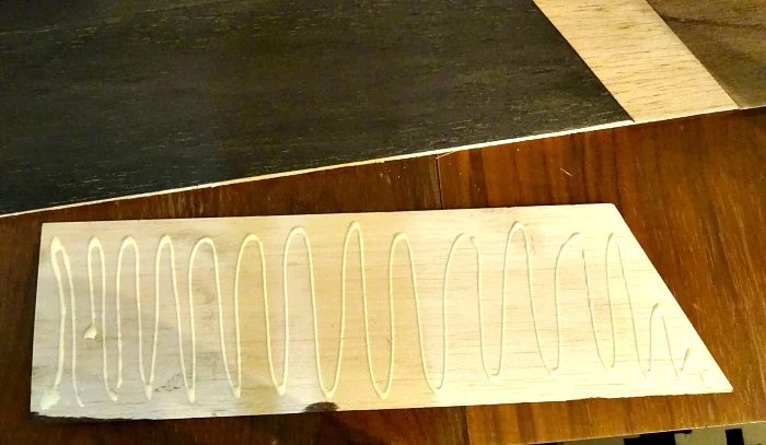 cut and stained balsa wood wood glued to thin plywood for unique table runner