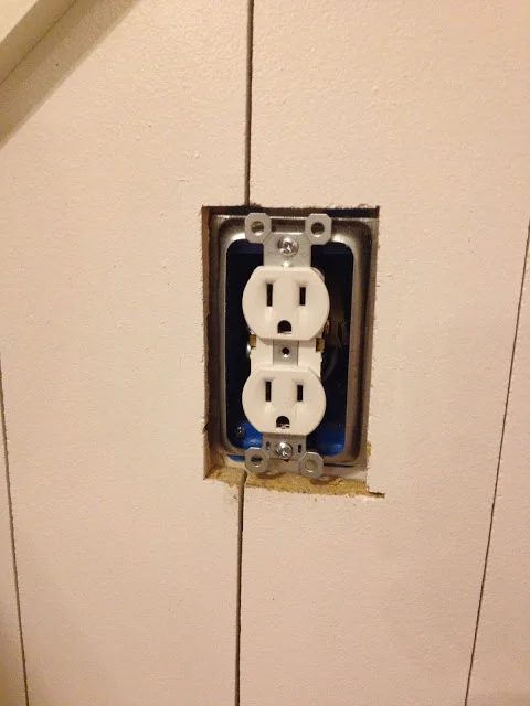 cut around the outlets for barn door wainscoting wall treatment