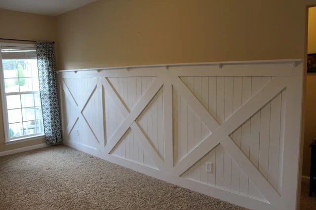 finished barn door wainscoting wall treatment with wall ledge topper