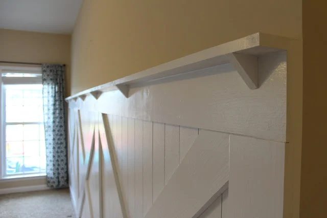 install reinforced ledge to top the barn door inspired wainscoting wall treatment