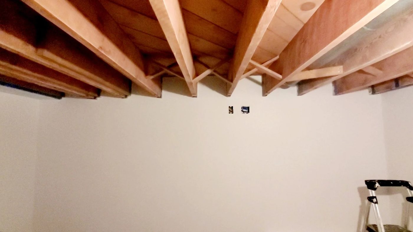 basement remodel with exposed ceiling beam joists