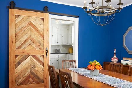 striking Doors - wood barn door with blue wall This Old House