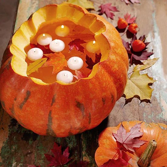 carved pumpkins with floating candles