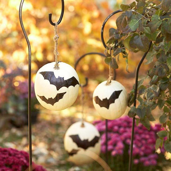hang pumpkins from plant holders or shepherds crooks BHG