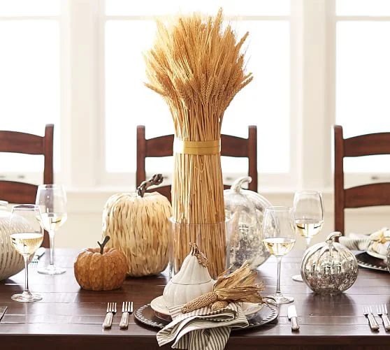 thanksgiving tablescape with mercury glass pumpkins and corn husk pumpkins and straw (via Pottery Barn)