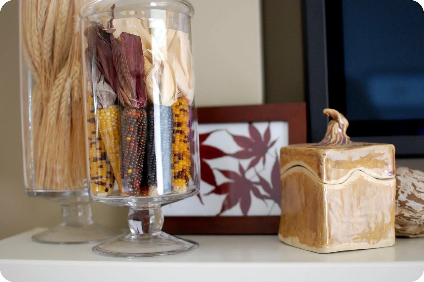 fall mantel with indian corn wheat and apothecary jars