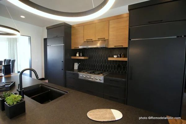 Modern Dark Gray Kitchen Cabinets With Light Wood Upper Cabinets, Black Tile Backsplash, UVPH House 27 Emerald Homes