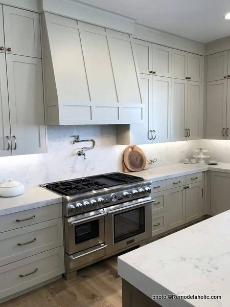 Light Gray Kitchen Cabinets With Range Hood, Tall Cupboards, White Countertops, SLPH 2018 Home 13 Magleby Communties