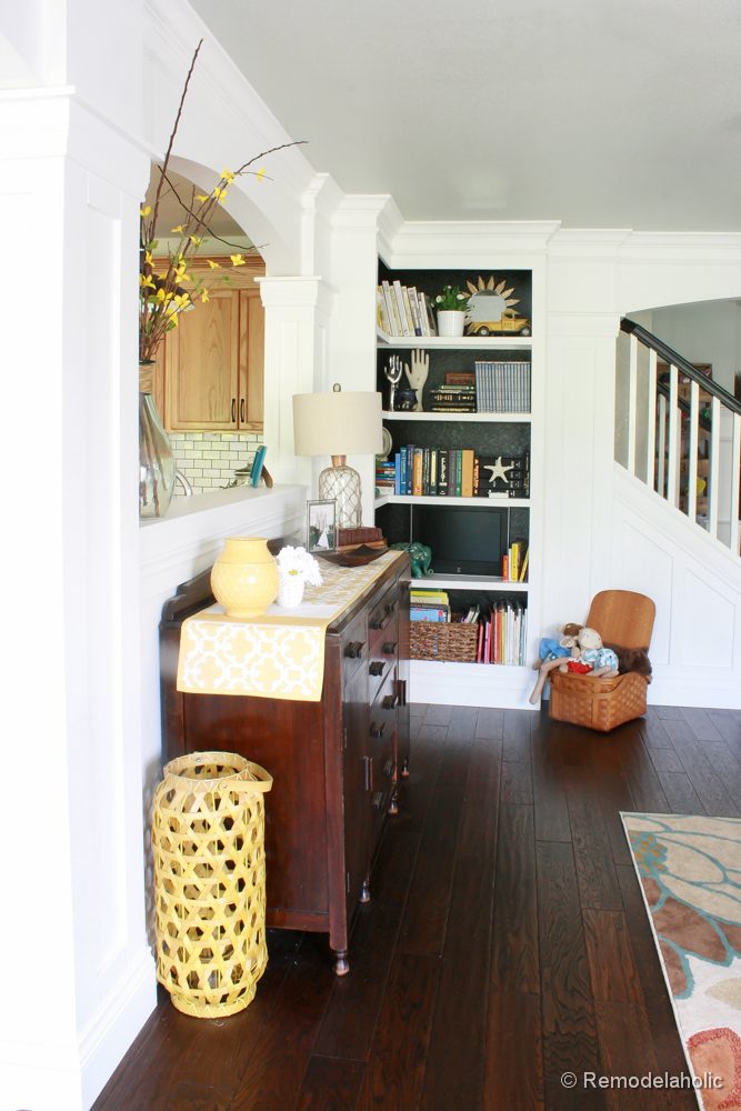 Living Room Remodel with yellow accents wood floors and built-in bookcases and columns with arches-22