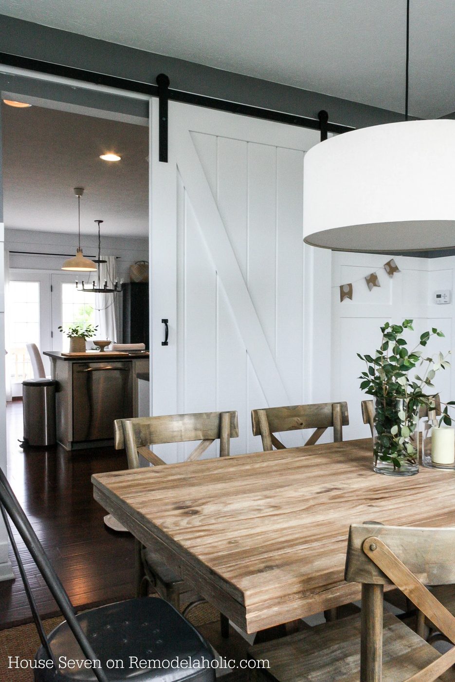Build a striking sliding barn door with great detail using siding! Free plans and walkthrough on @Bekob