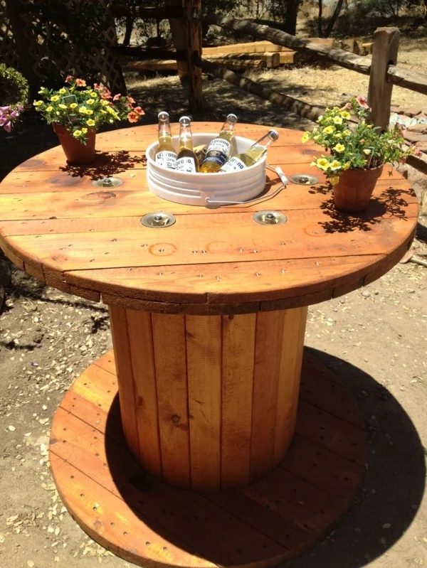 wood spool table with bucket in the center for drink cooler, original source unknown, via @Bekob