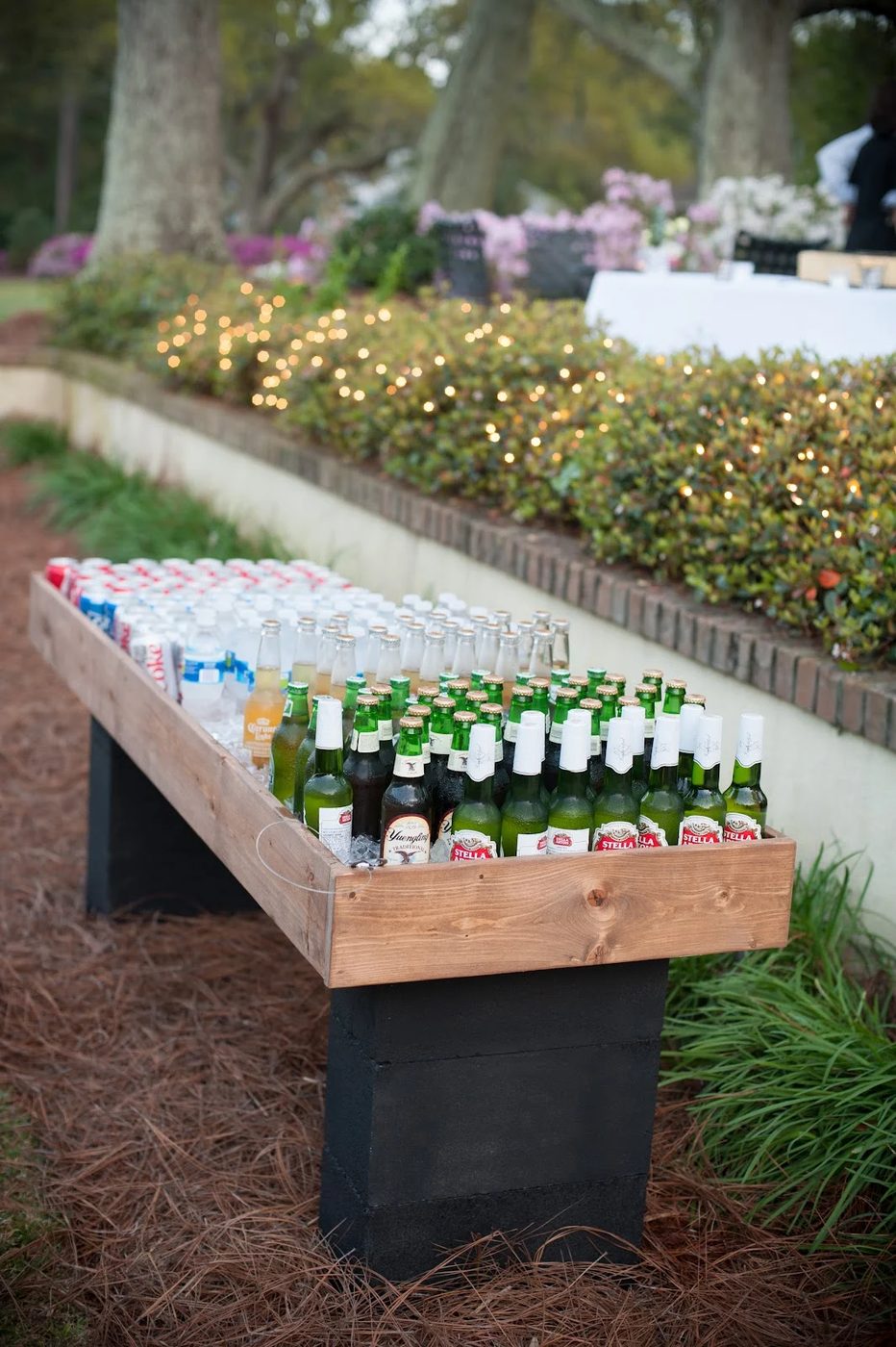 a shallow wood box on top of some cinder blocks makes an straightforward beverage cooler for a party, by MichaelaRaeJ