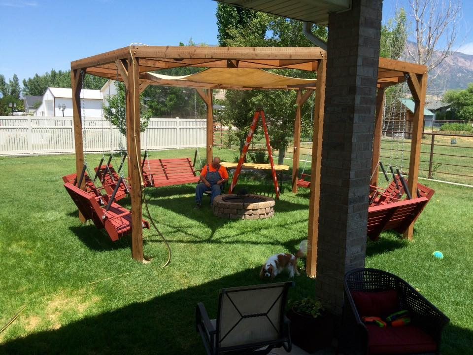 Handmade round pergola with swings, firepit and shade screen featured on @Bekob