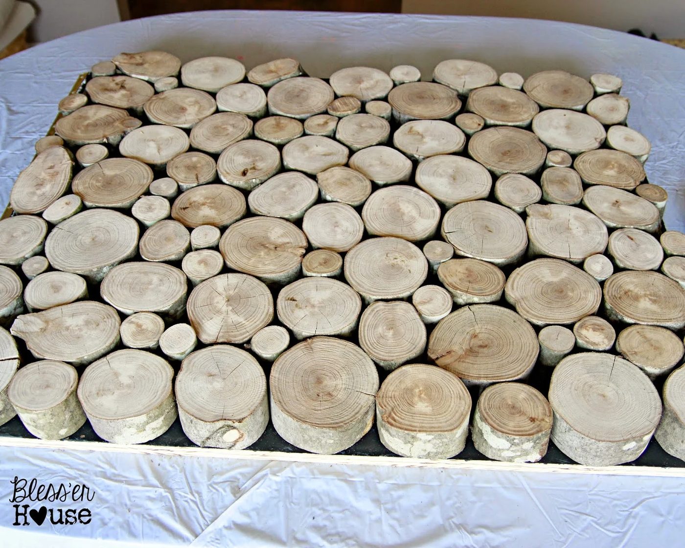 handmade stacked log frontpiece of faux fireplace 2 - Blesser House featured on @Bekob