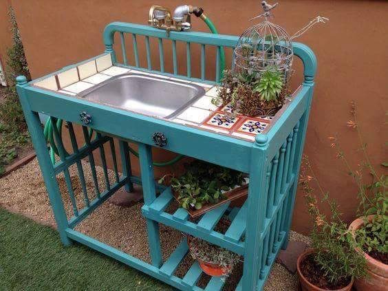 upcycled crib or changing table into a potting bench using an old sink