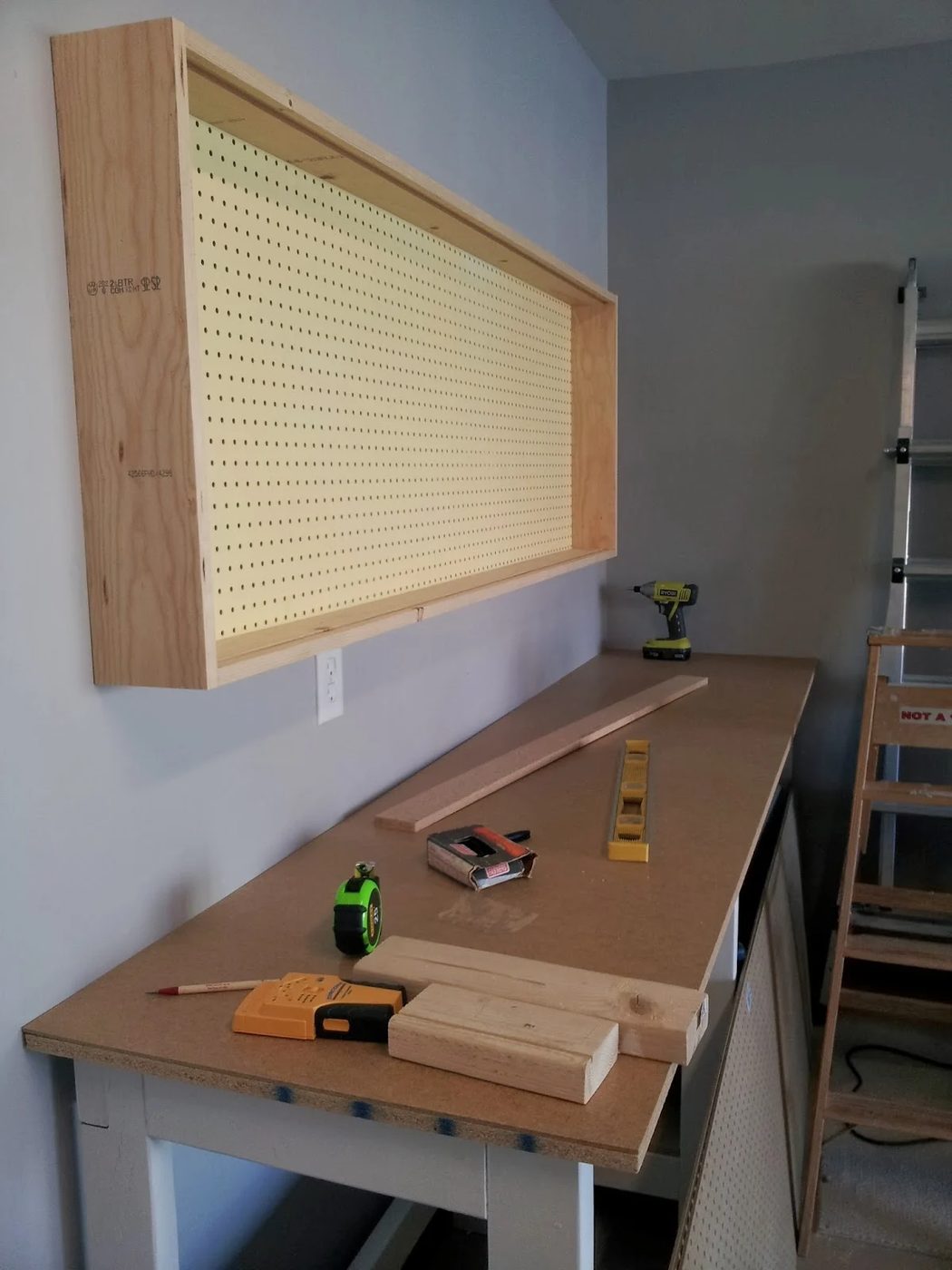 base of pegboard wall-mounted tool organizing cabinet, featured on Bekob.com