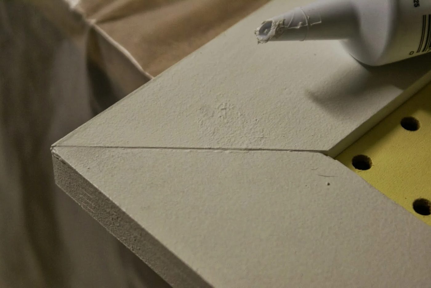 caulked seams of mitered corners on pegboard tool organizer doors, featured on Bekob.com
