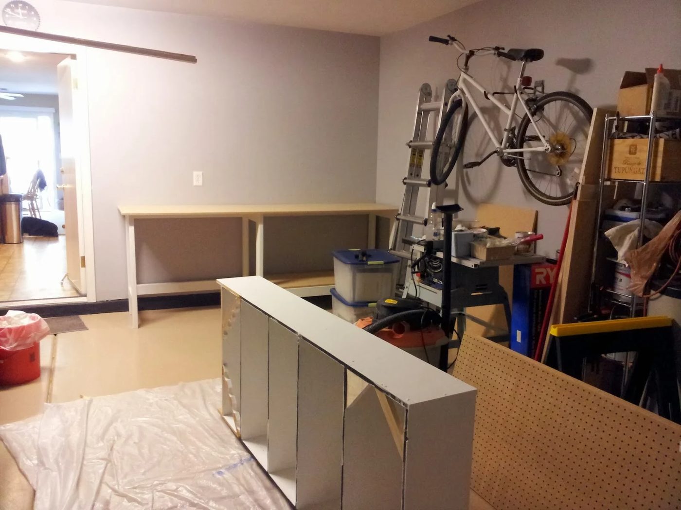 painting and priming a bookshelf for organizing garage tools, featured on Bekob.com