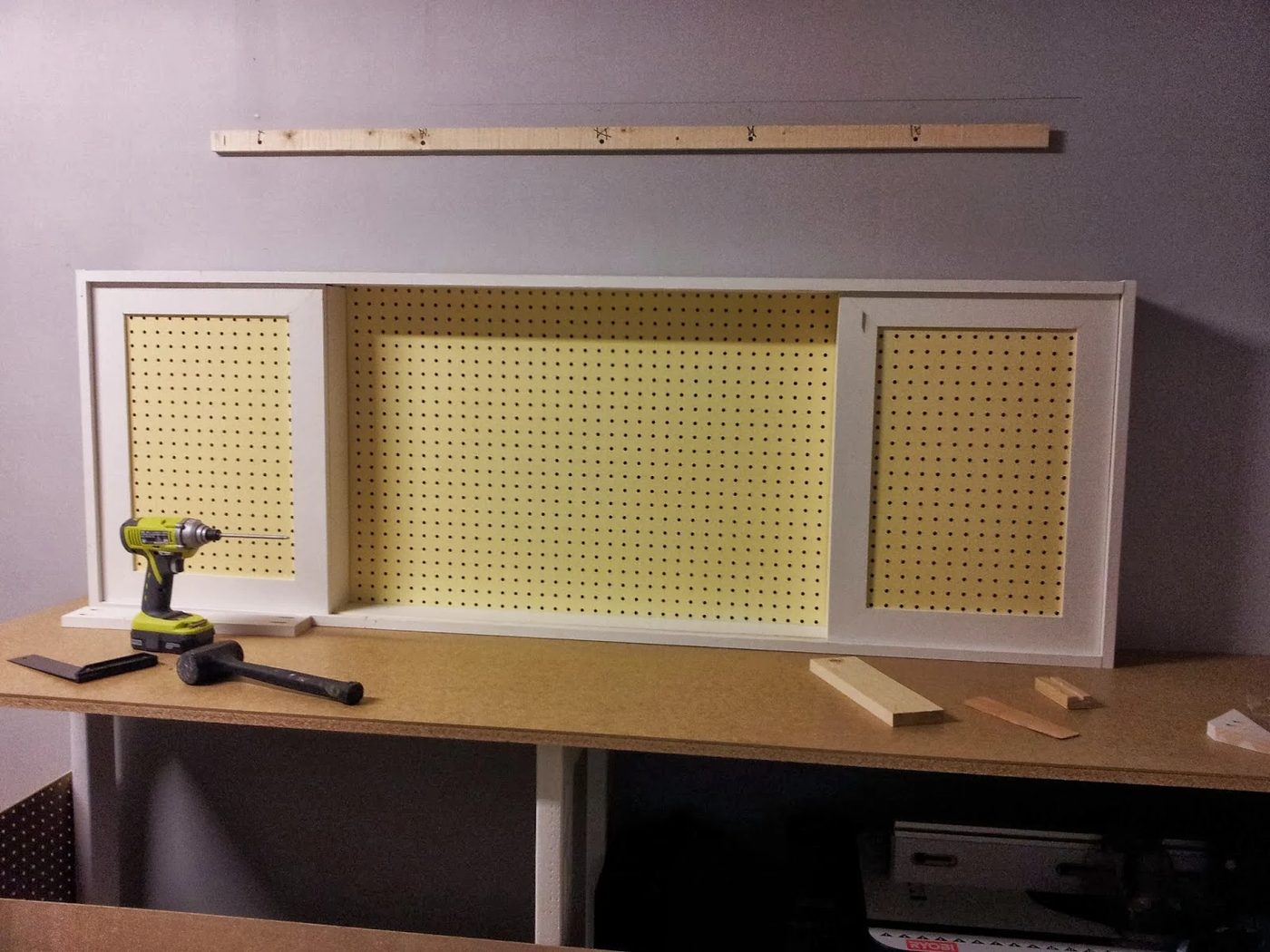 assembled pegboard tool cabinet with sliding doors, featured on Bekob.com