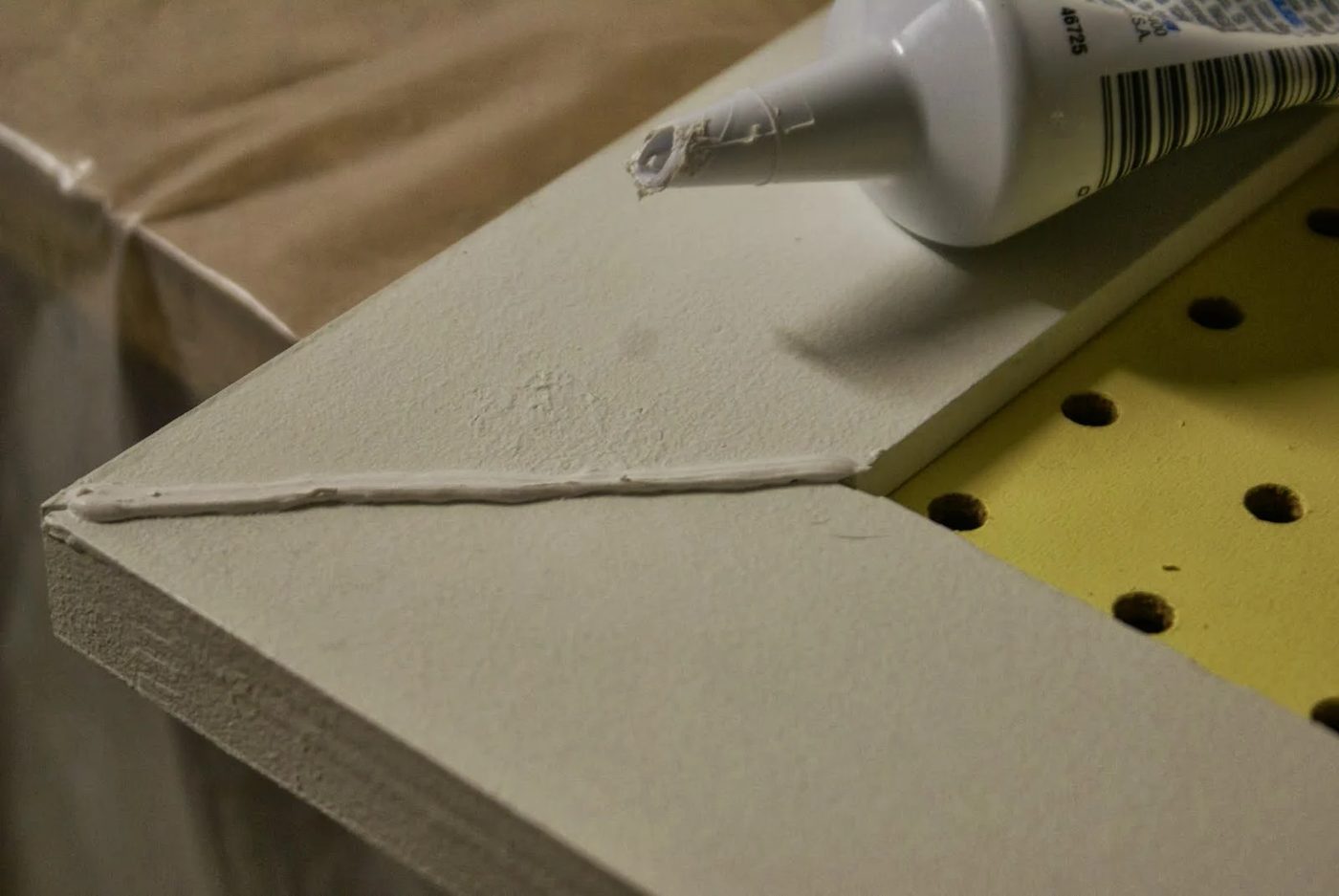 caulk seams of mitered corners on pegboard tool organizer doors, featured on Bekob.com