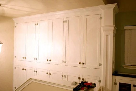 wall of built-in cabinets for family room storage, Bekob