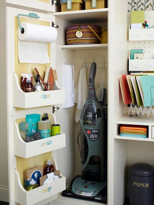 organized cleaning closet with wood cabinet door storage bins