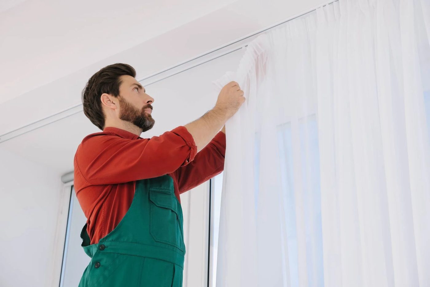 Man Fixing Curtain