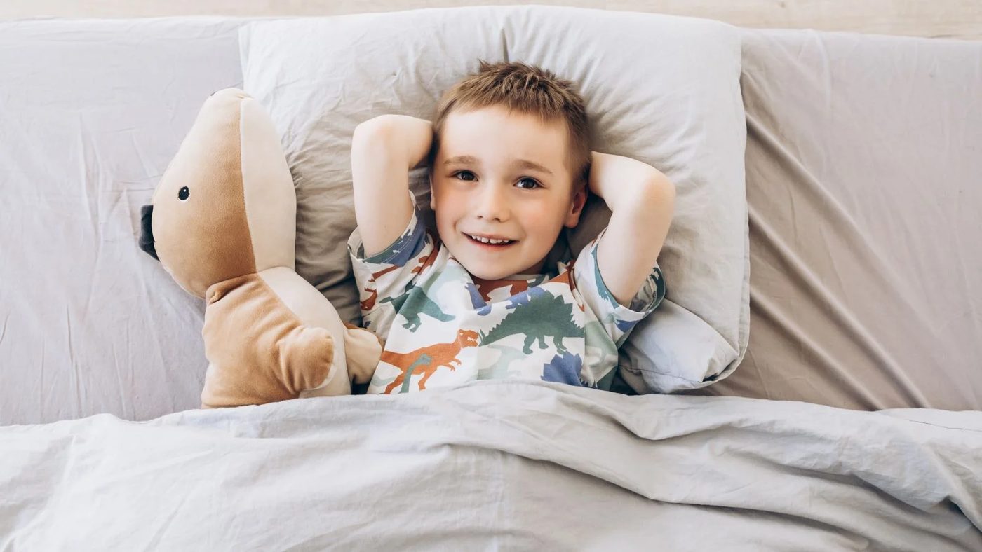 Happy Kid On A Bed