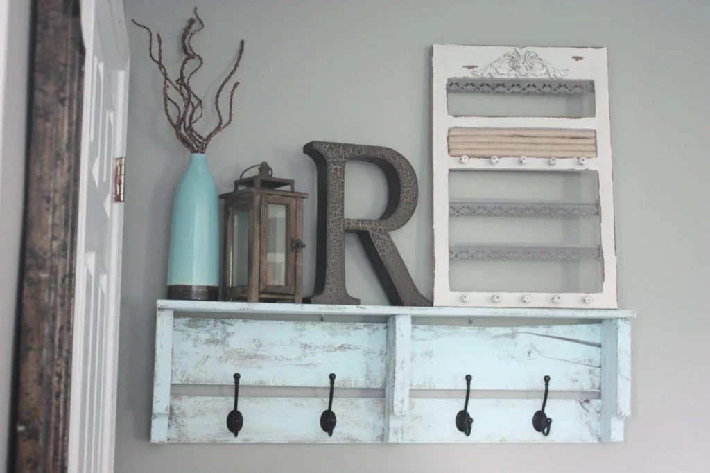 Pallet coat rack with hooks and 16 clever organization pallet hacks featured on Bekob.com