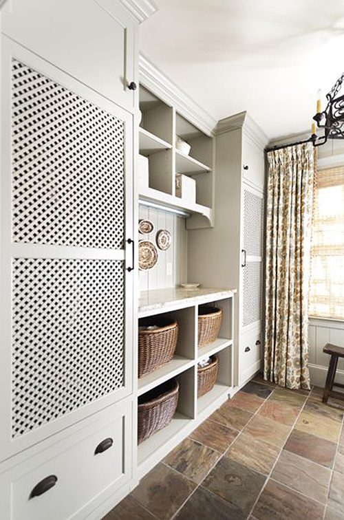 laundry room with hidden machines and possibly vented doors featured on Remodelahoilc.com