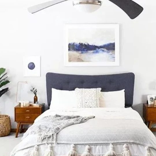 White And Blue Bedroom, Blue Headboard, White Bedding, Wood Side Tables And Blue And White Artwork On The Walls