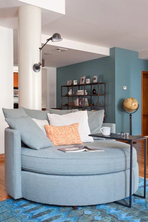 Accent wall color is Aegean Teal from Benjamin Moore. Color Spotlight on Bekob. Image via Revamp Interior Design.