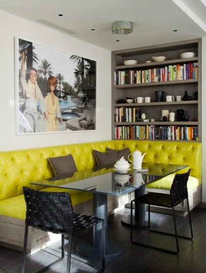 green and gray corner banquette with bookshelf