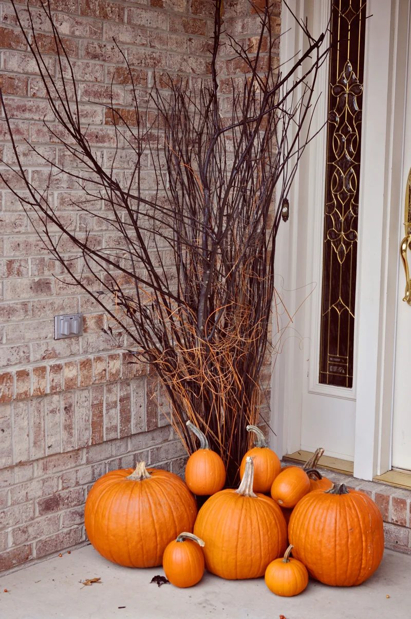 straightforward Halloween porch decor, spray painted branches and pumpkins | direct Halloween Decor options and Tutorials at Bekob.com