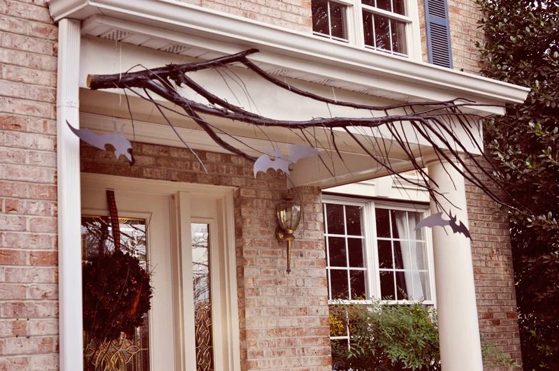 Branches hung from the porch and cardboard or paper bats, so straightforward! | direct Halloween Decor options and Tutorials at Bekob.com