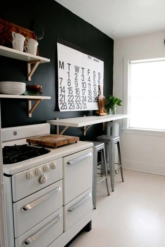 painted black kitchen wall (via the Kitchn)