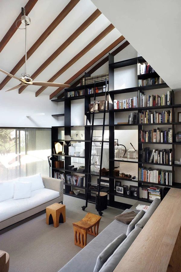 black painted tall built-in bookshelves (via A House In The Hills)