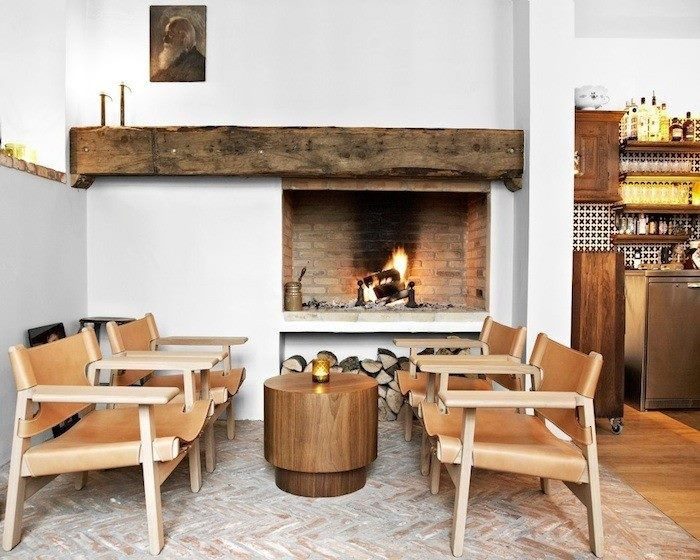 rough wood mantel for an off-center fireplace