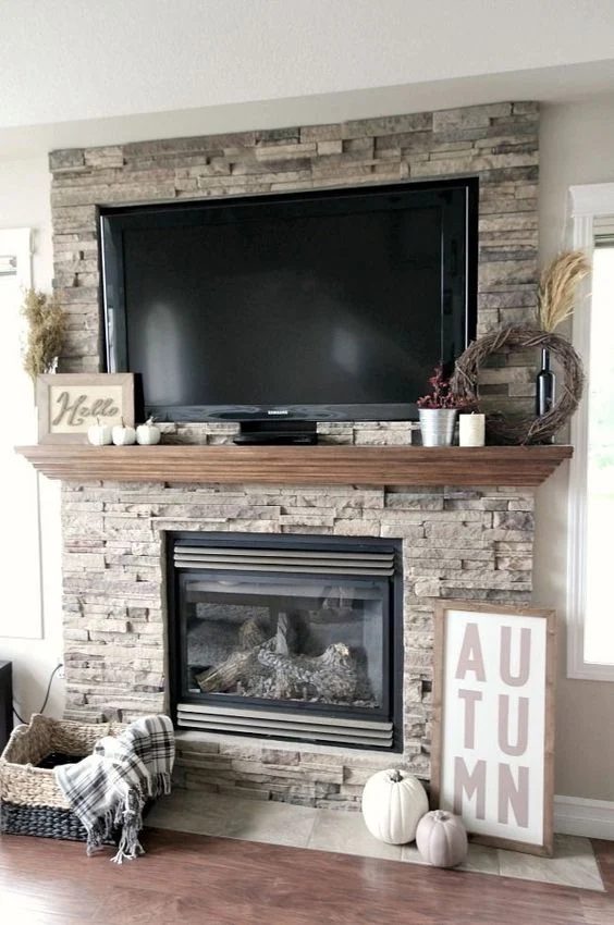 options for Decorating Around a TV Over the Fireplace Mantel, stone mantel with decor via Love Create Celebrate