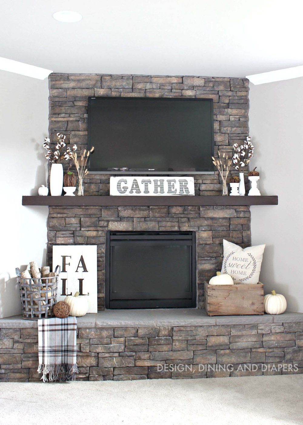 options for Decorating Around a TV Over the Fireplace Mantel, stone fireplace and mantel decor via Design Dining and Diapers