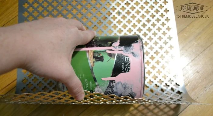 roll the sheet of punched metal over a round object so itll hug the lamp ring