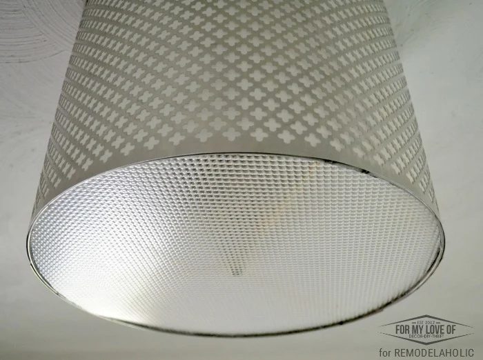 ceiling light panel disguises the innerds of the old and ugly light fixture