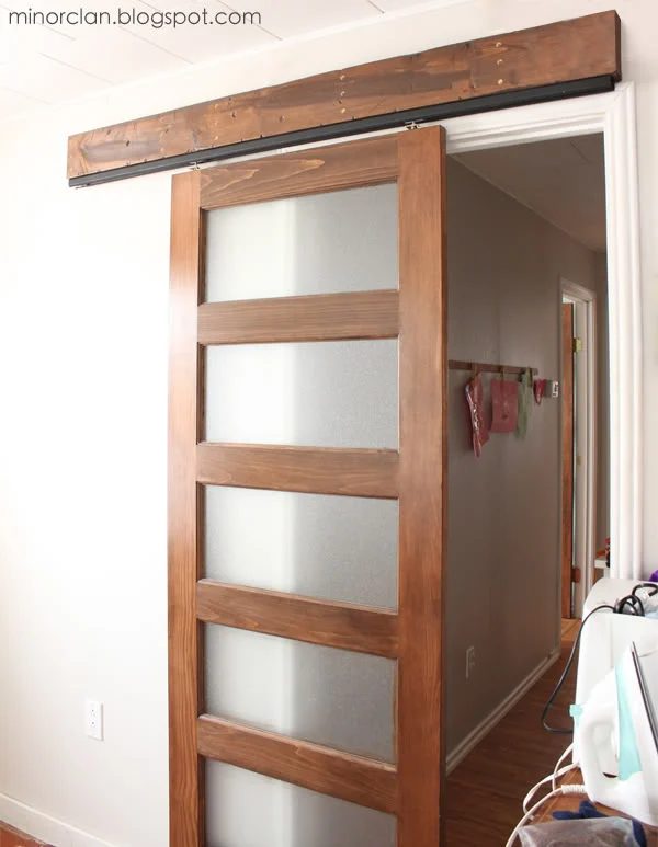handmade sliding barn door using a closet door track - via The Lettered Cottage
