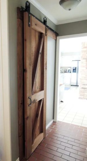 build and hang a wooden barn door on Handmade rolling hardware - Do or Handmade