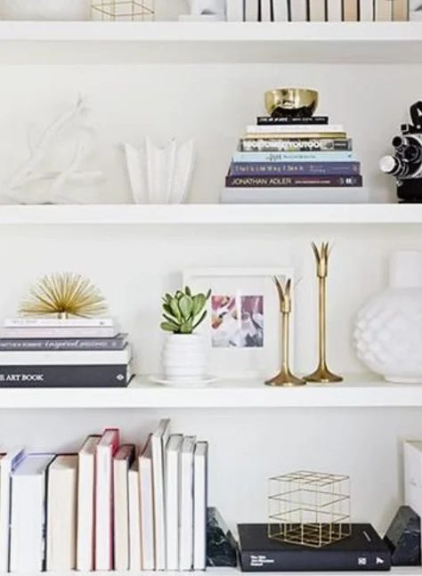 White Bookshelves With Books, Gold Accent Decor And White Vases