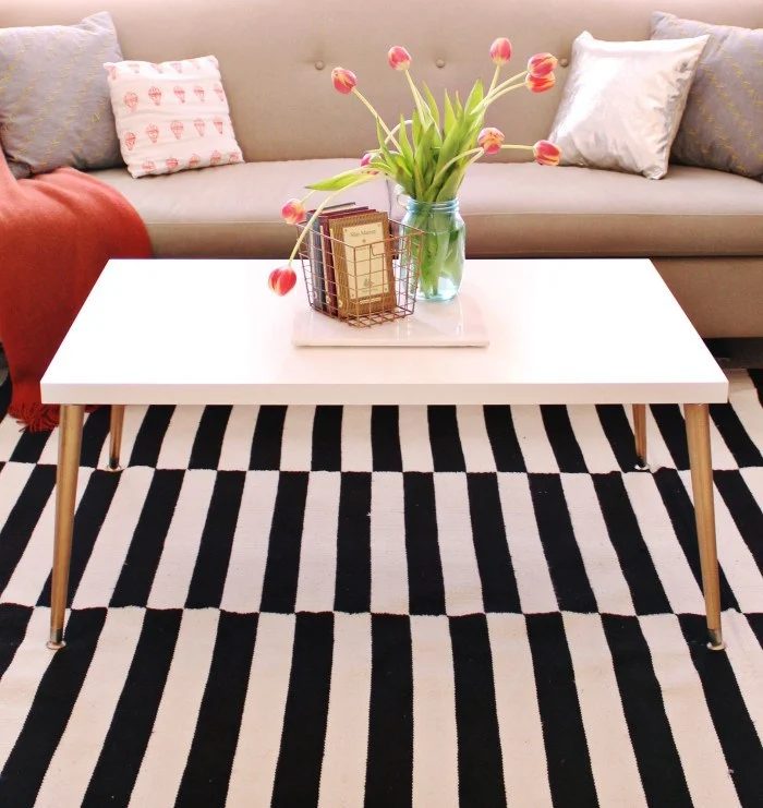 White And Black Rug With White Coffee Table And Gold Metala Legs