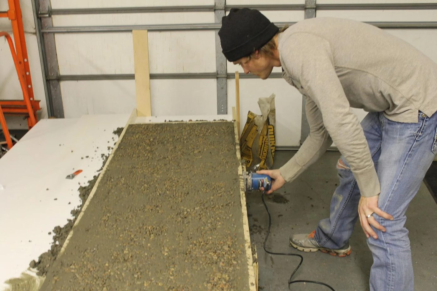 When DIYing concrete countertops, use a palm sander to vibrate the molds and get out the air bubbles for a sturdy solid slab countertop.